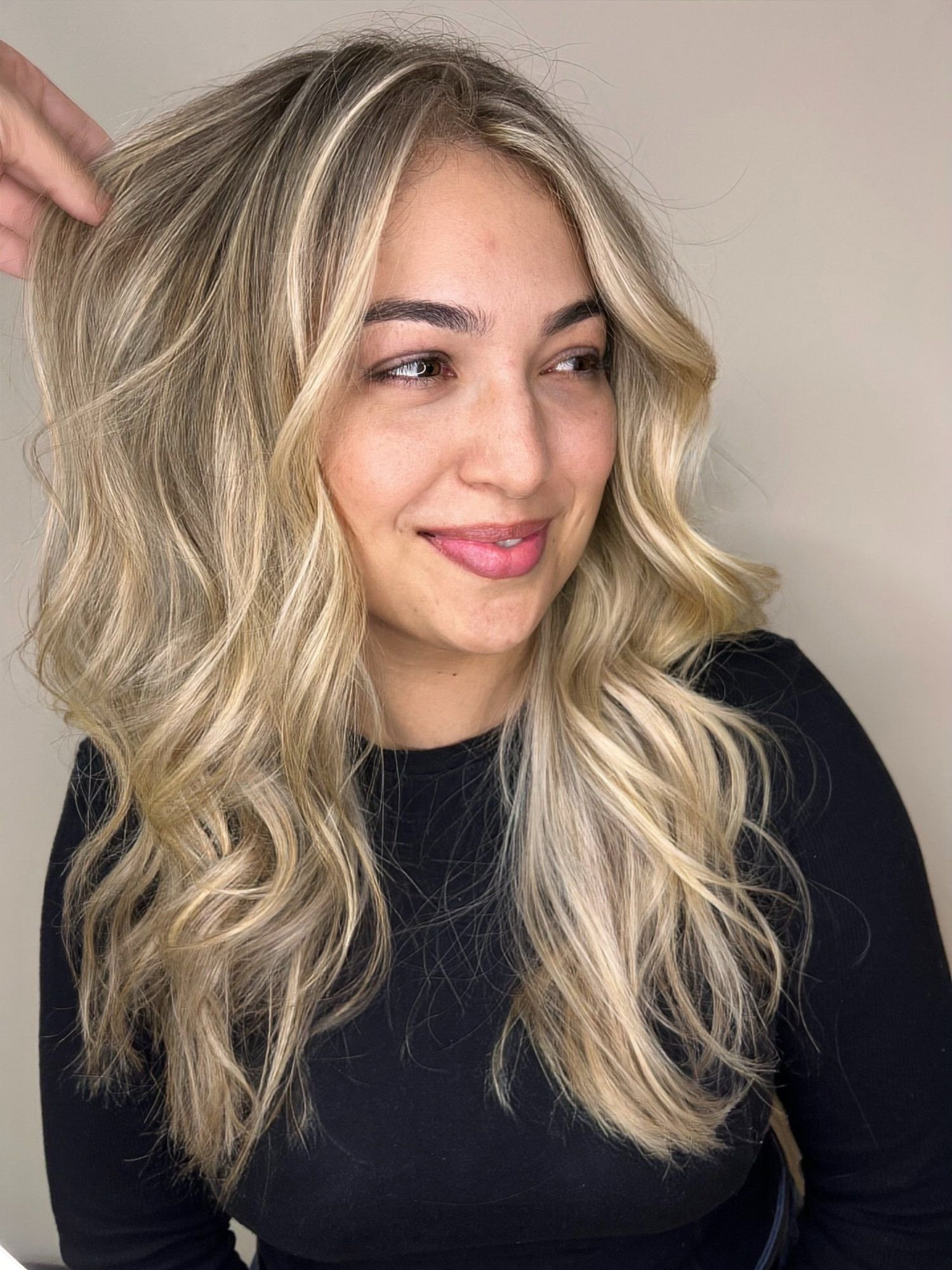 Loiro claro bege perolado com ondas largas, cliente sorrindo no salão